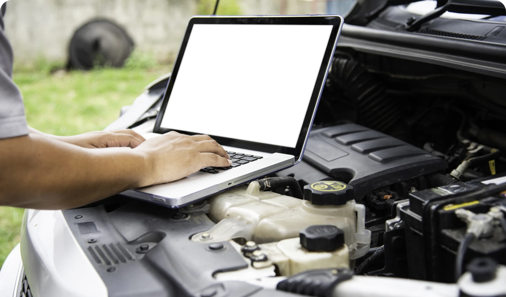 Laptop on car engine for repairs